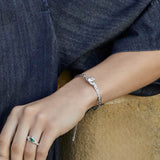 model wearing sterling silver claddagh bangle