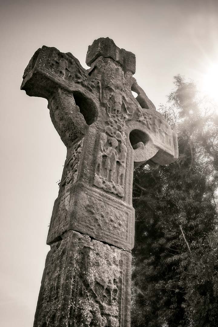 free standing Celtic cross stone monument with a carving on it