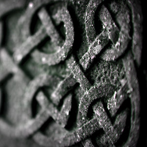 Close-up of intricate Celtic knot pattern on a stone surface