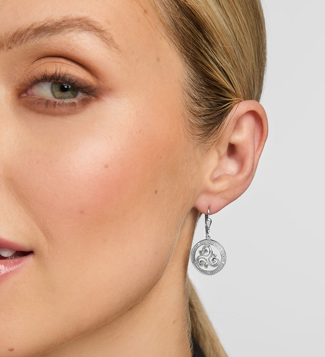 close-up image of celtic spiral drop earrings on a model