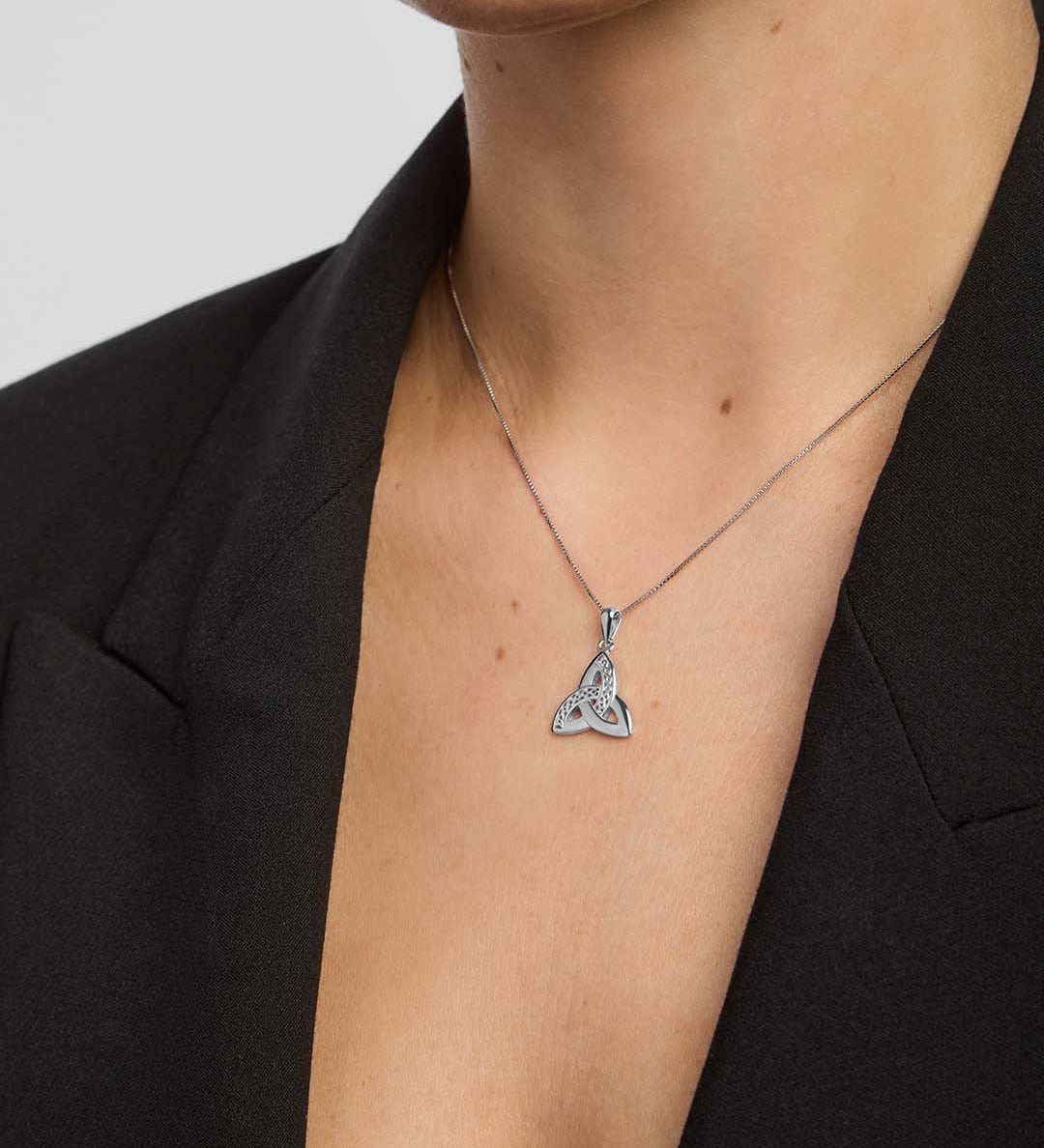 close-up image of celtic trinity knot pendant on a model