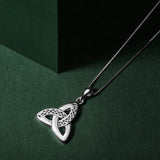 lifestyle image of silver celtic trinity knot pendant. Three gently curved loops intertwine seamlessly creating the iconic triangular knot shape, symbolising an unbroken connection with no beginning or end.