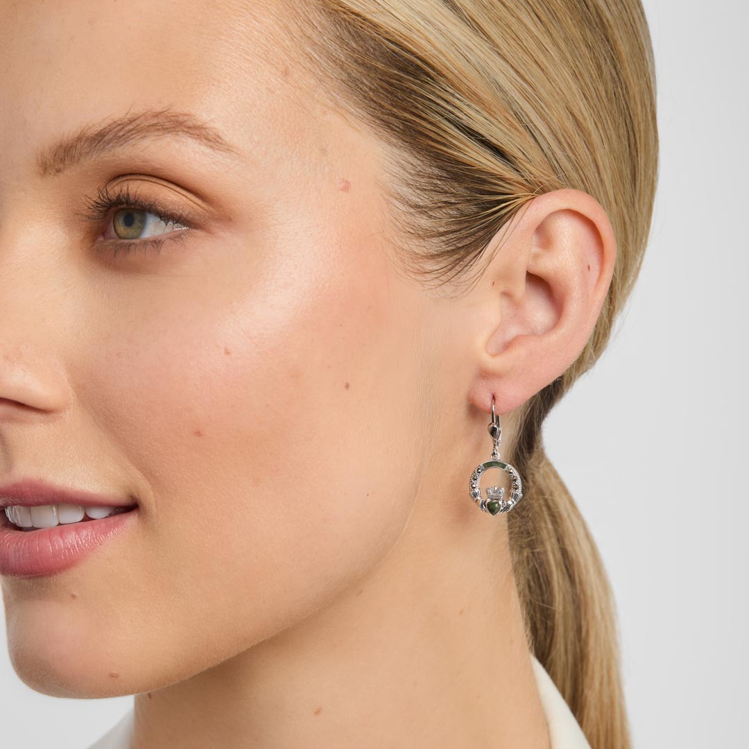model wearing green marble claddagh earrings from Solar