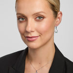 a female model wearing green crystal claddagh pendant and earrings
