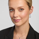 a female model wearing green crystal claddagh pendant and earrings