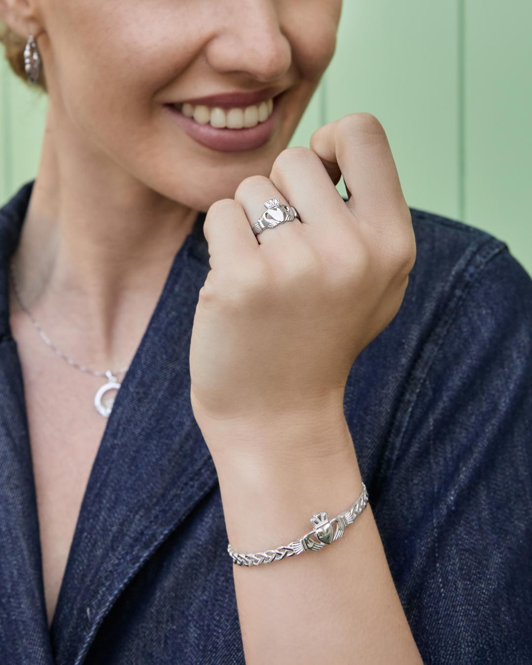 model wearing claddagh jewellery set of ring bracelet necklace and earrings