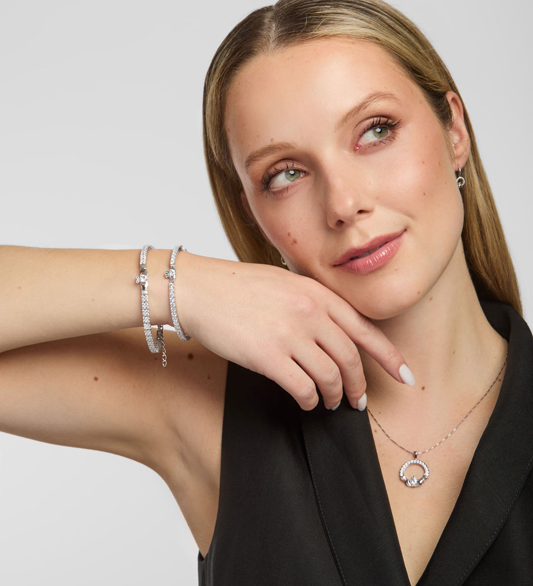  lifestyle shot of Solvar Claddagh tennis bracelet and bangle on a woman's wrist, emphasizing detail and shine