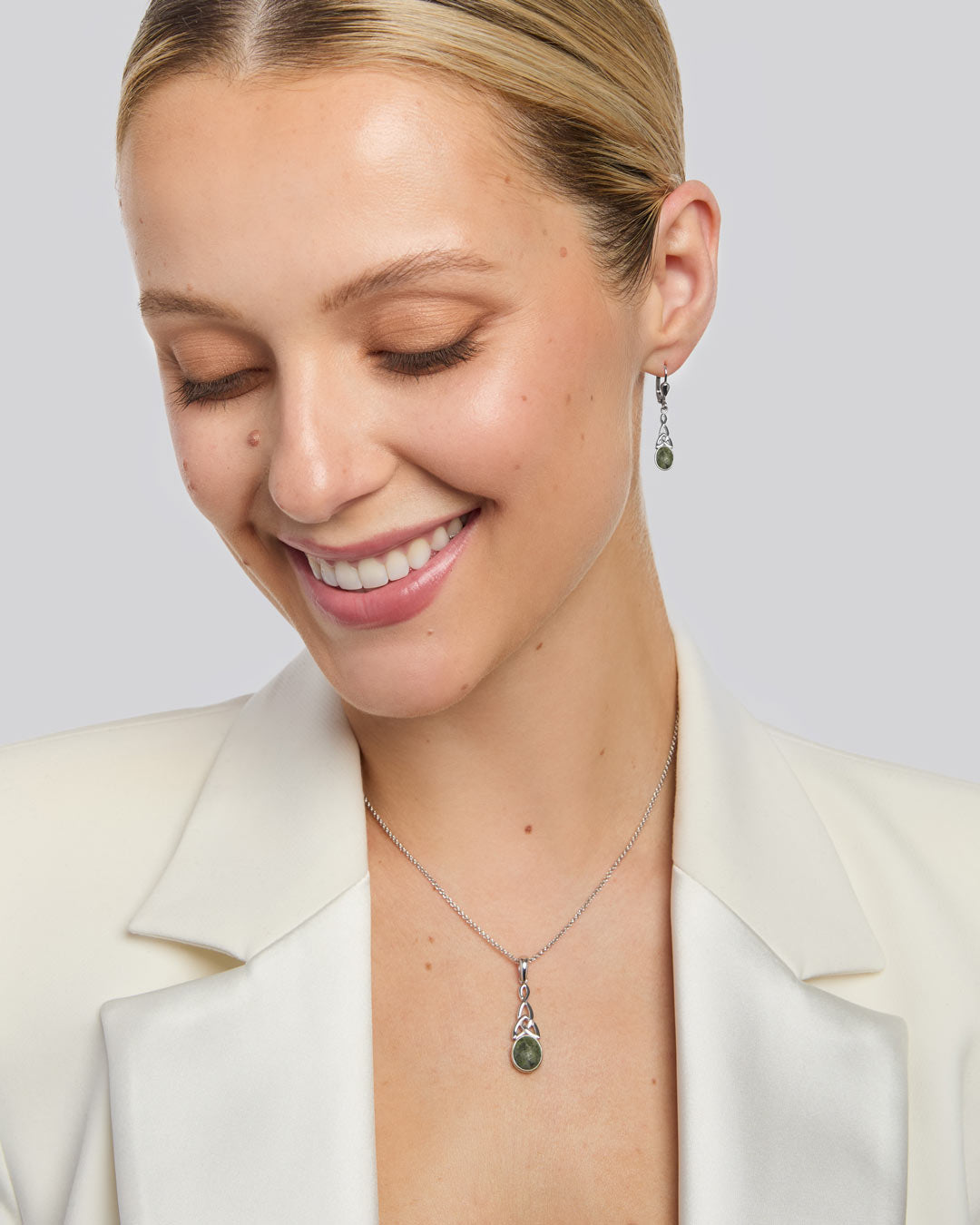 model wearing green marble Celtic knot necklace and earrings set from Solvar