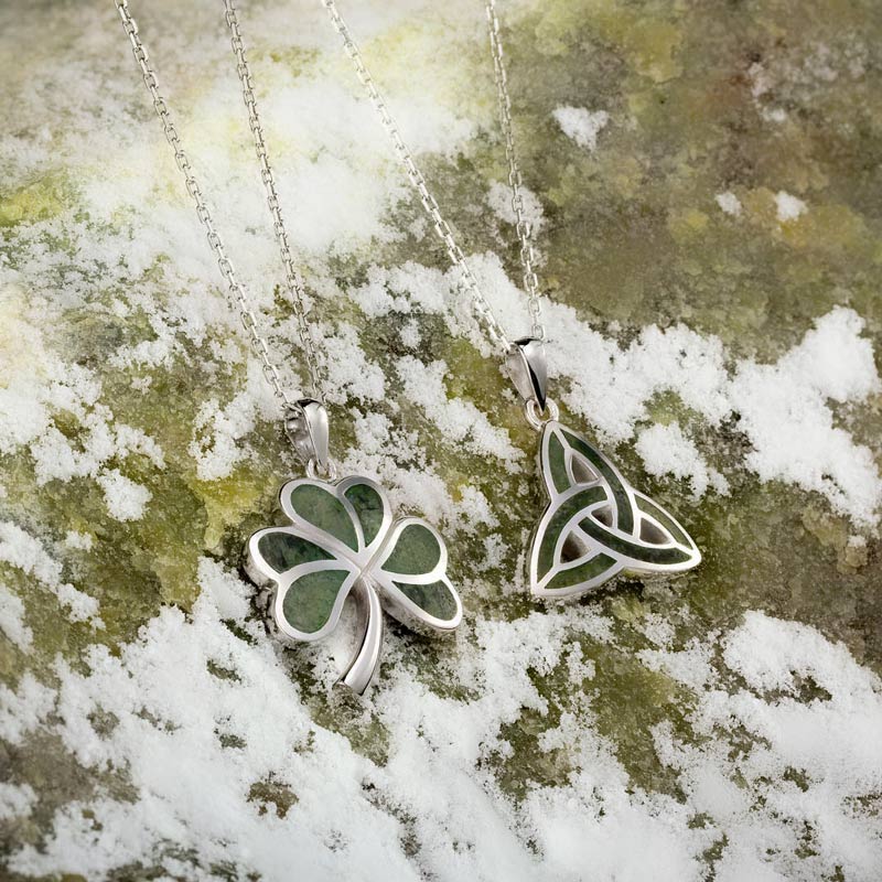 styled image of sterling silver connemara marble trinity knot pendant and shamrock pendant