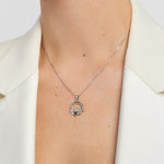 green marble and marcasite claddagh necklace on a model