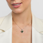 Heart-shaped green marble pendant necklace worn by a person with a white background
