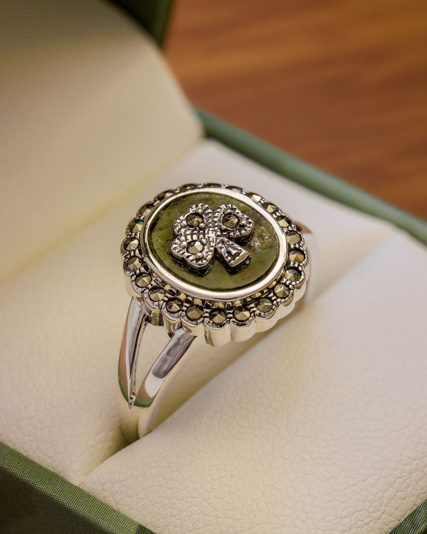 close up lifestyle image of connemara marble and marcasite shamrock ring 