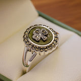 close up lifestyle image of connemara marble and marcasite shamrock ring 