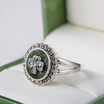 lifestyle closeup image of silver marcasite and connemara marble shamrock ring