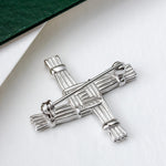 lifestyle image of the back of Connemara marble St Brigid's Cross brooch from Solvar