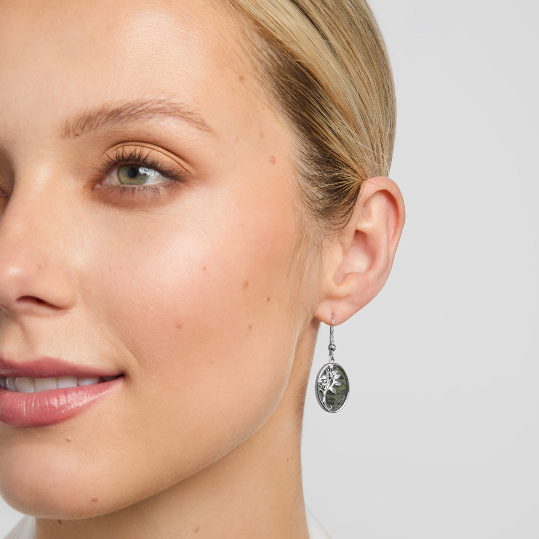green marble Celtic tree of life drop earrings on a model