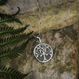 lifestyle image 2 of silver connemara marble tree of life necklace s46669 on green marble stone