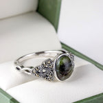 lifestyle closup image of marcasite and connemara marble trinity knot ring 2