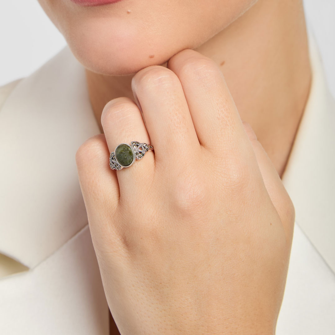 oval green marble celtic trinity knot ring on a model