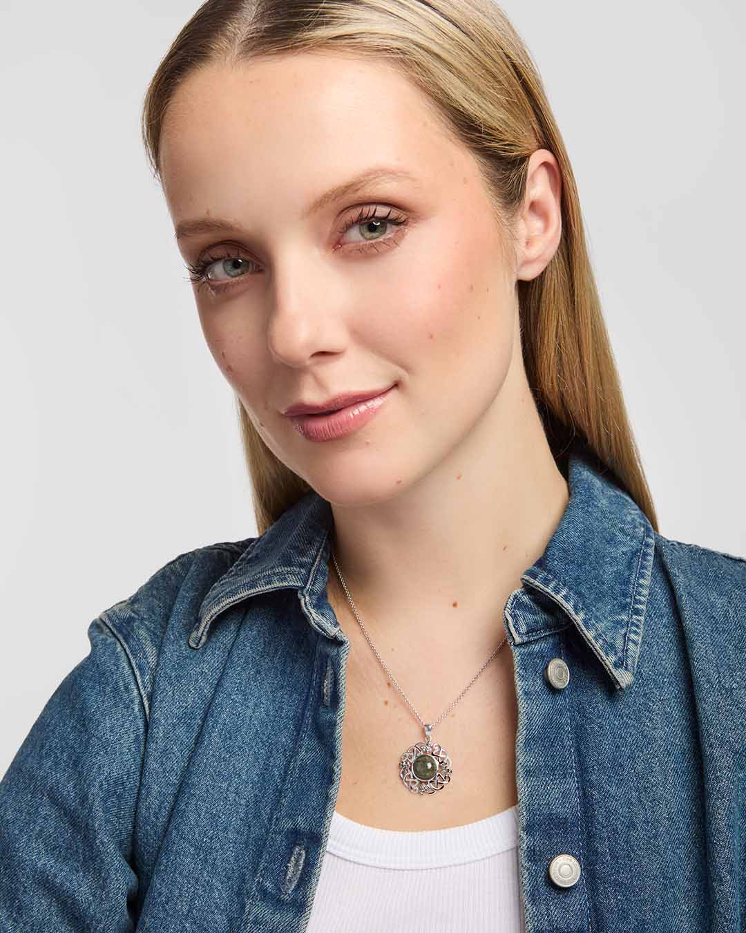 female model wearing Connemara marble and marcasite Celtic shamrock pendant with intricate knotwork on a silver chain