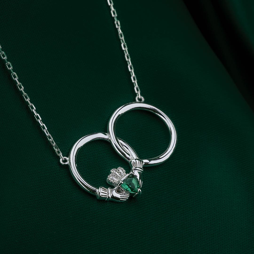 styled image of crystal claddagh circle pendant on green background