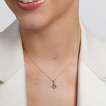 yellow gold cz shamrock necklace presented on a model