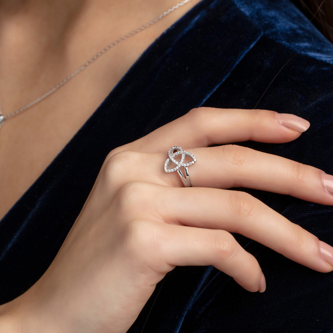 closeup image of silver Trinity Knot ring on the model's hand