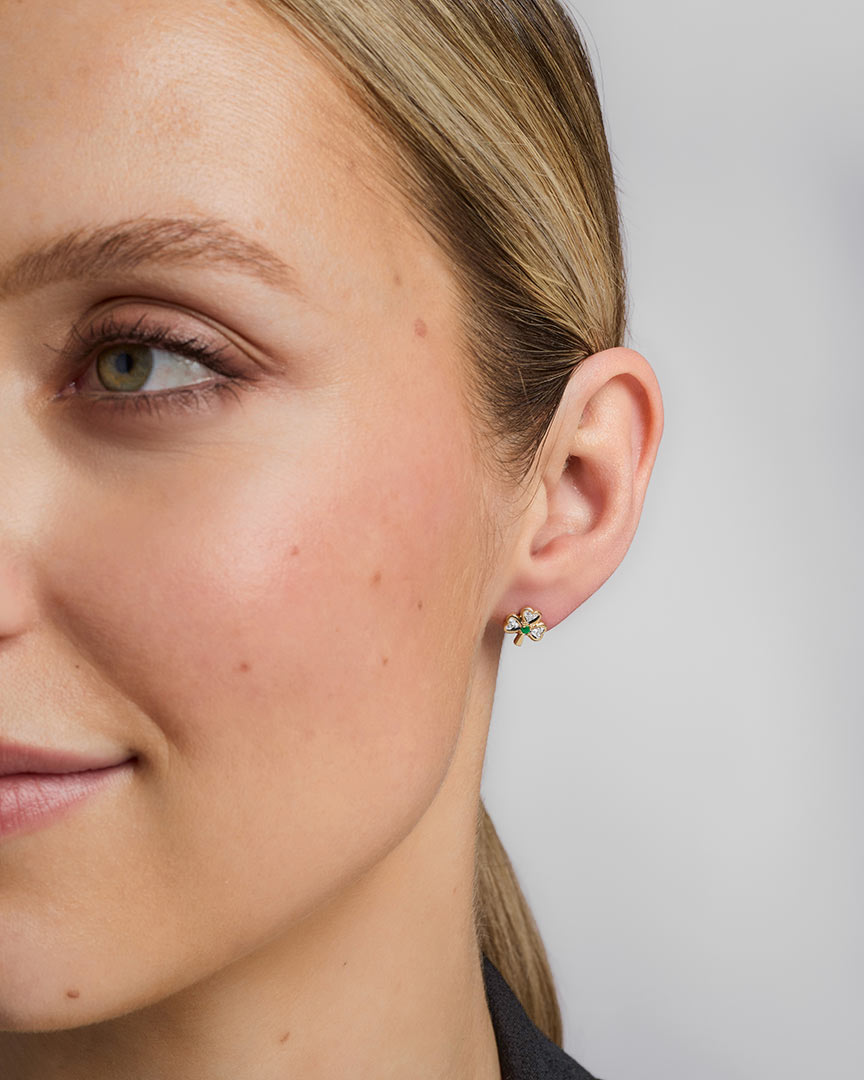 a model wearing diamond & emerald shamrock stud earrings s3975