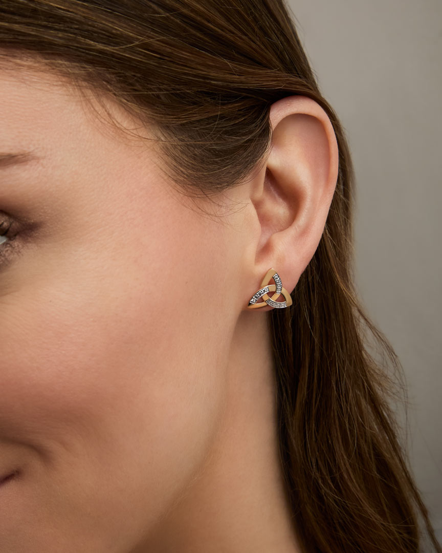 yellow gold Trinity Knot stud earrings on a model