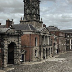 Dublin Castle building with clock tower under a cloudy sky