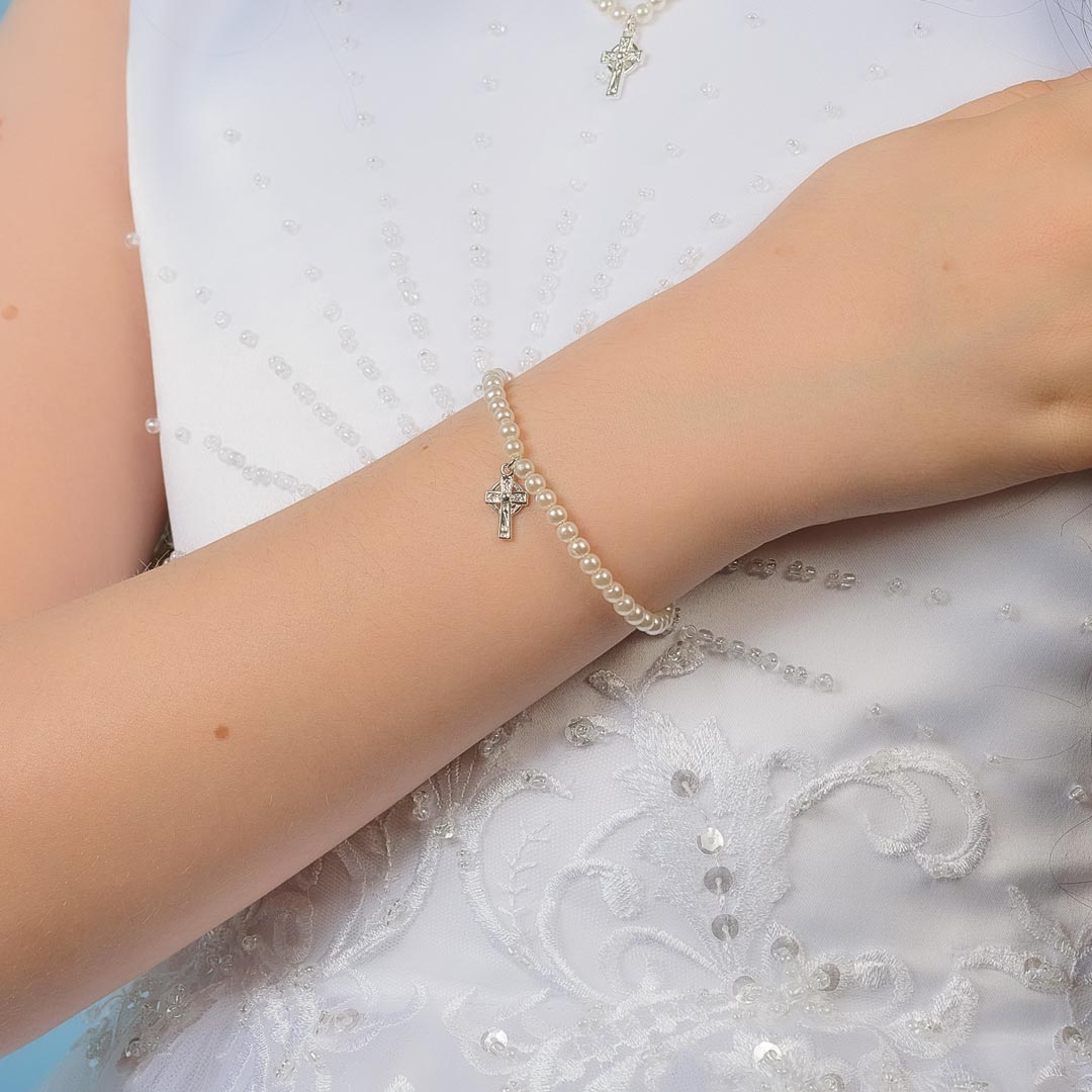 a model mearing first communion cross bracelet