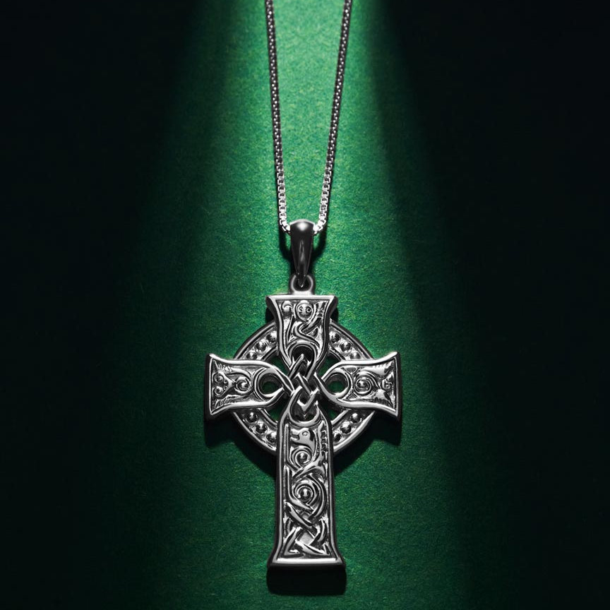 styled image of small four apostles celtic cross pendant s46604 on green background