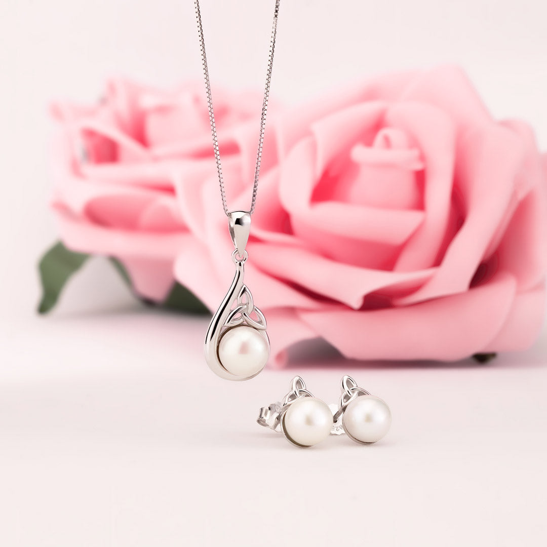 lifestyle image of matching freshwater peal Trinity Knot necklace and earrings from Solvar