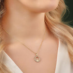 yellow gold cs round claddagh necklace on a model
