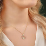 yellow gold cs round claddagh necklace on a model