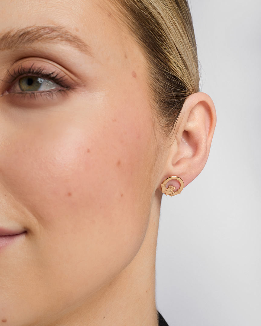 gold claddagh stud earrings on a model 2