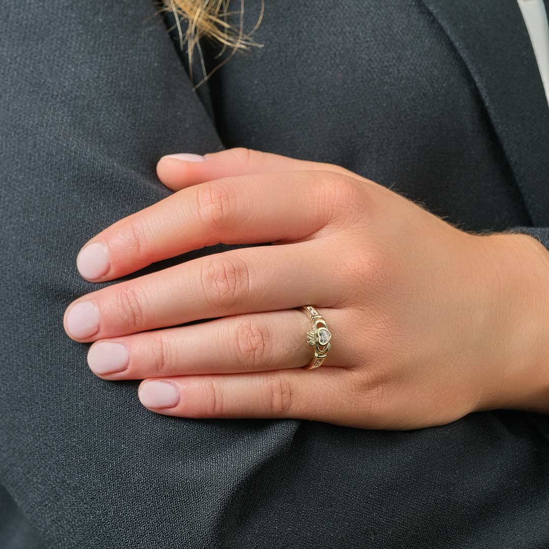 a model wearing gold cubic zirconia claddagh ring