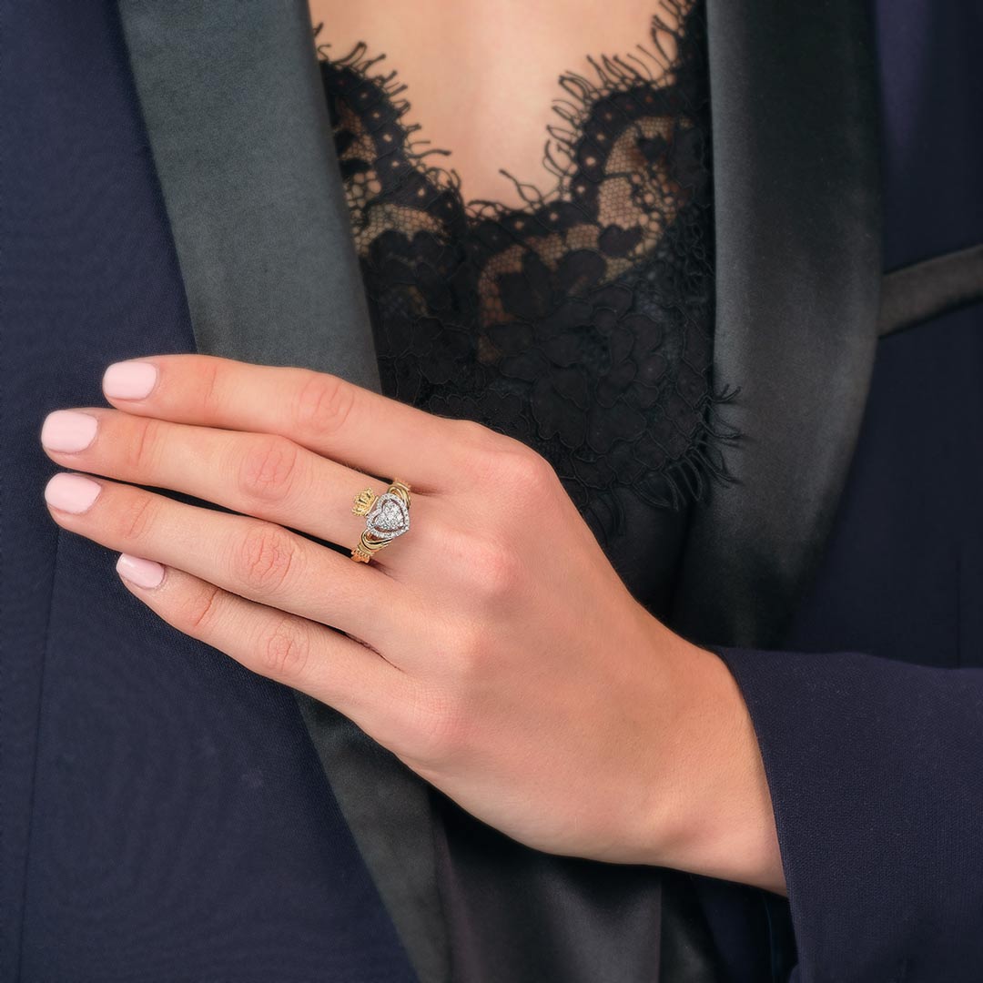 a model wearing gold diamond heart claddagh ring s21096 1