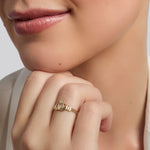 gold mini Claddagh ring on a model's hand 1