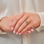 a model wearing Solvar gold green agate claddagh ring