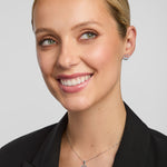 green crystal claddagh necklace and earrings set on a model