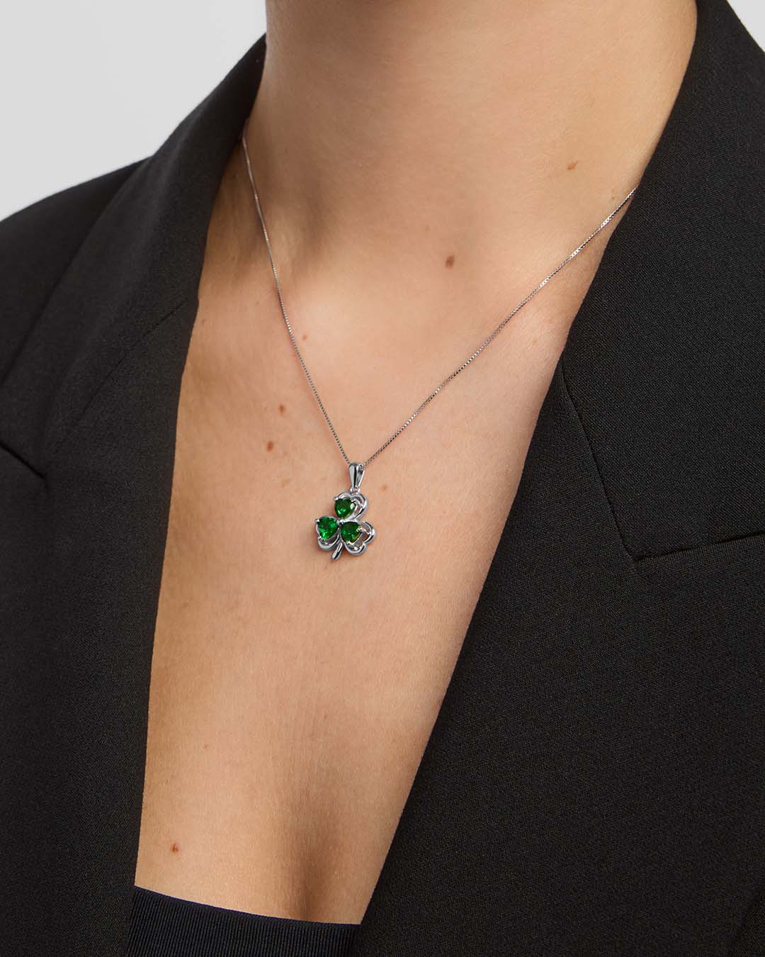 close-up image of green crystal Shamrock necklace on a model