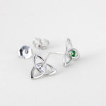 lifestyle image of front and back sides of Solvar green crystal silver trinity knot stud earrings s33767