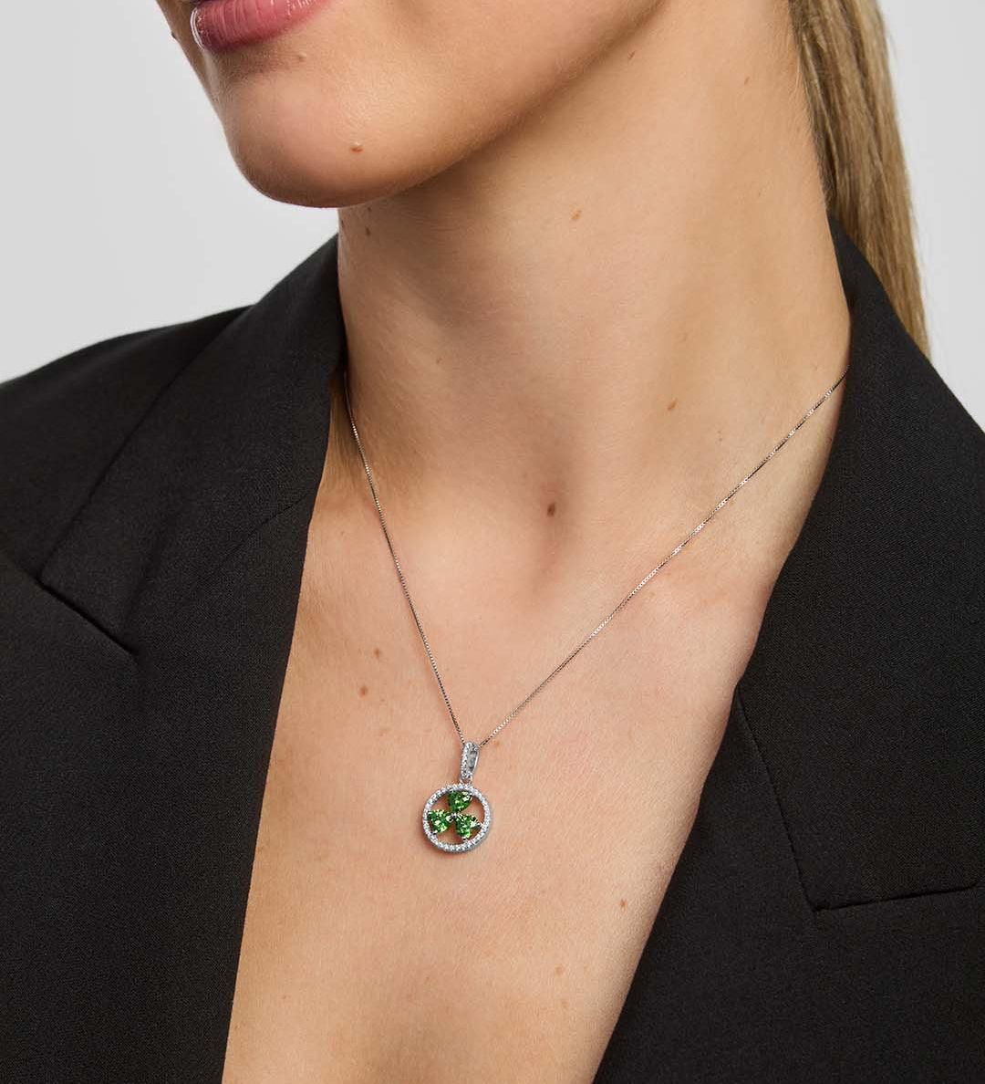 a female model wearing a green crystal Shamrock necklace