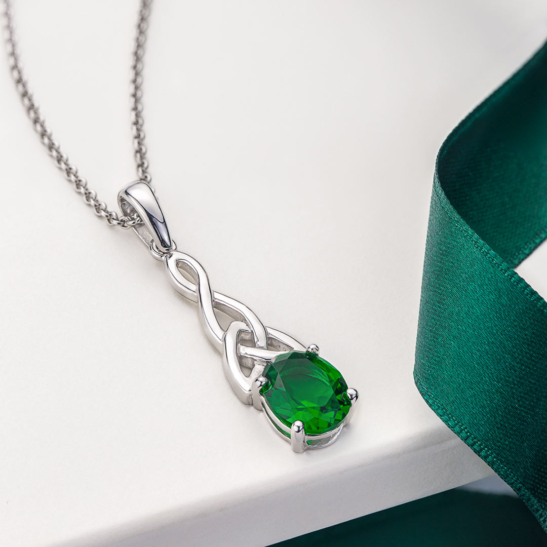 lifestyle image of Solvar green cz trinity knot necklace in silver
