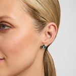 Close-up of a female model wearing green Shamrock stud earrings from Solvar
