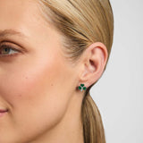 Close-up of a female model wearing green Shamrock stud earrings from Solvar