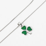 lifestyle image of green enamel shamrock necklace on silver trace chain