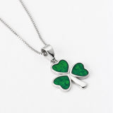 close up image of green enamel shamrock necklace on silver trace chain