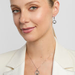 model wearing Claddagh necklace and matching earrings embellished with connemara marble and marcasite